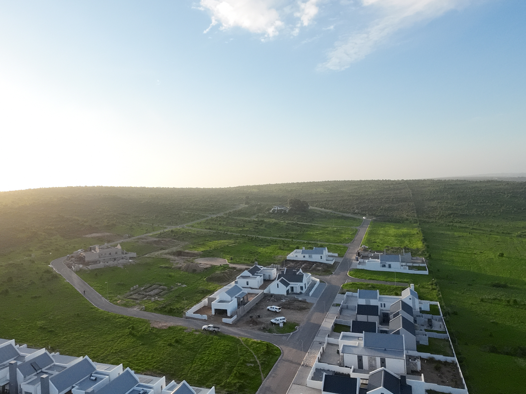 Aerial of Phase 3 & 4 plots and completed homes at sunset